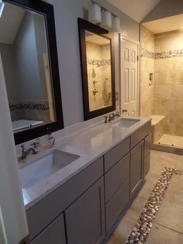 Double-sink bathroom vanity with marble top and pebble tile inlay by Aaron Steven Construction
