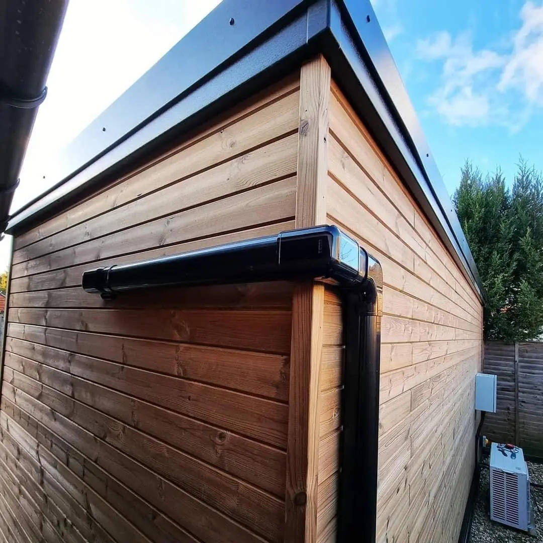 Horizontal timber cladding detail with black gutter