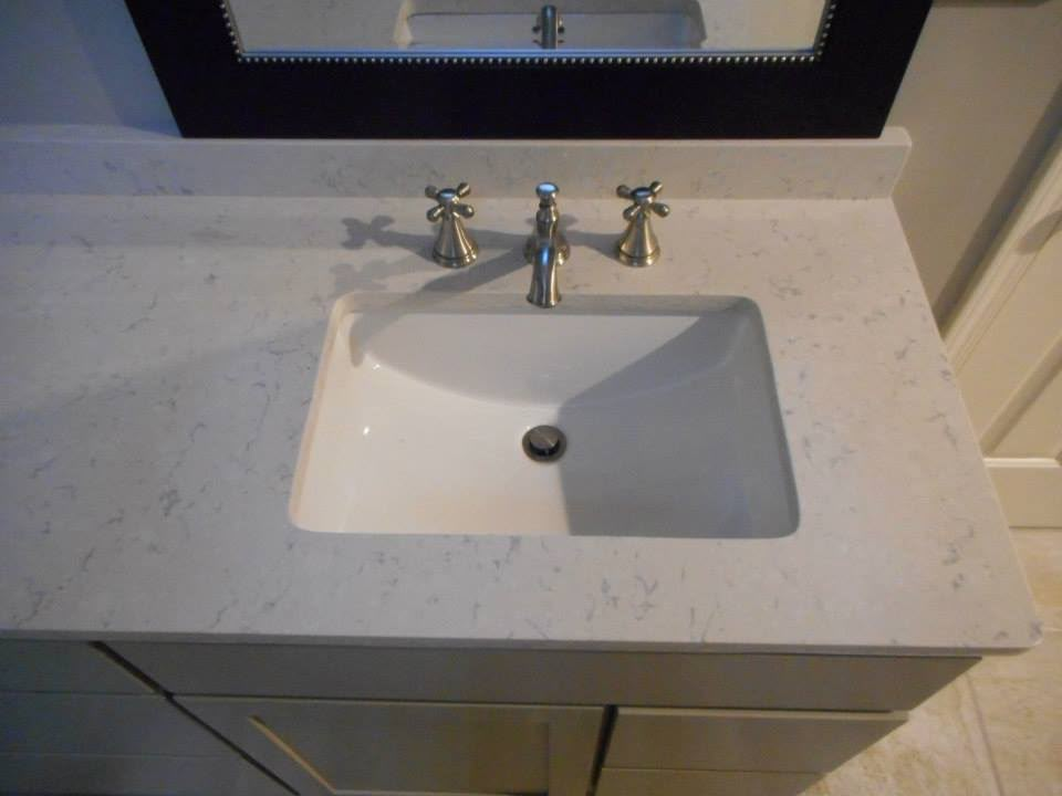 White stone undermount basin with cross-handle taps fitted by Aaron Steven Construction