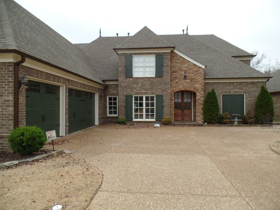 Two-storey brick family home with garage and aggregate driveway built by Aaron Steven Construction