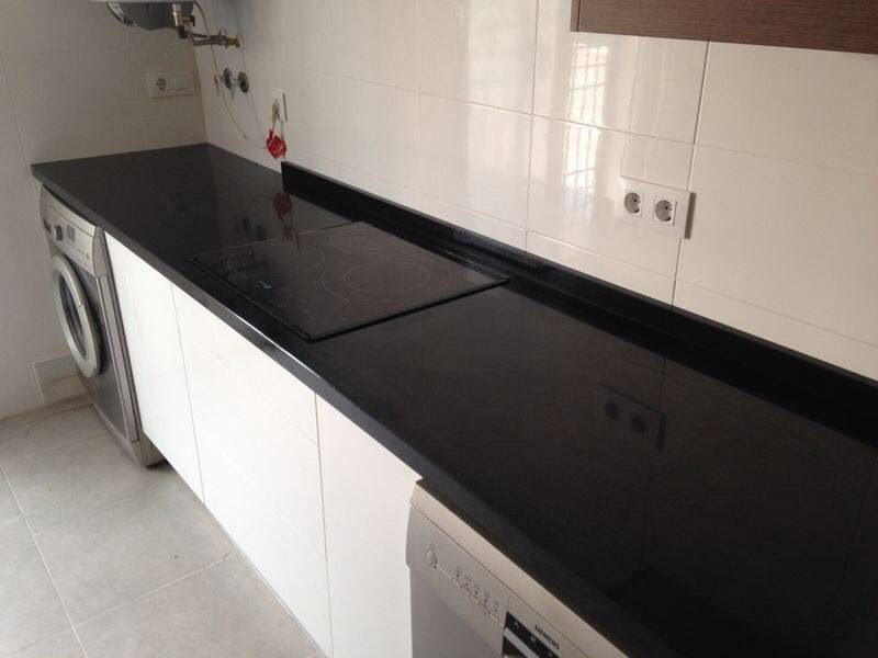 Utility room with black stone worktop, Siemens washing machine and dishwasher by Aaron Steven Construction