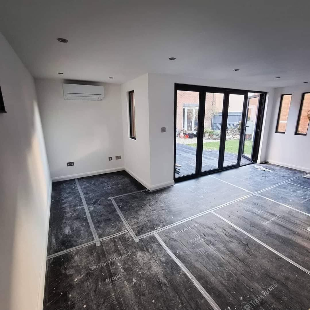 Refurbished room with black folding glass doors and floor protection
