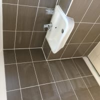 Crisp dark wall tiling and basin by Aaron Steven Construction